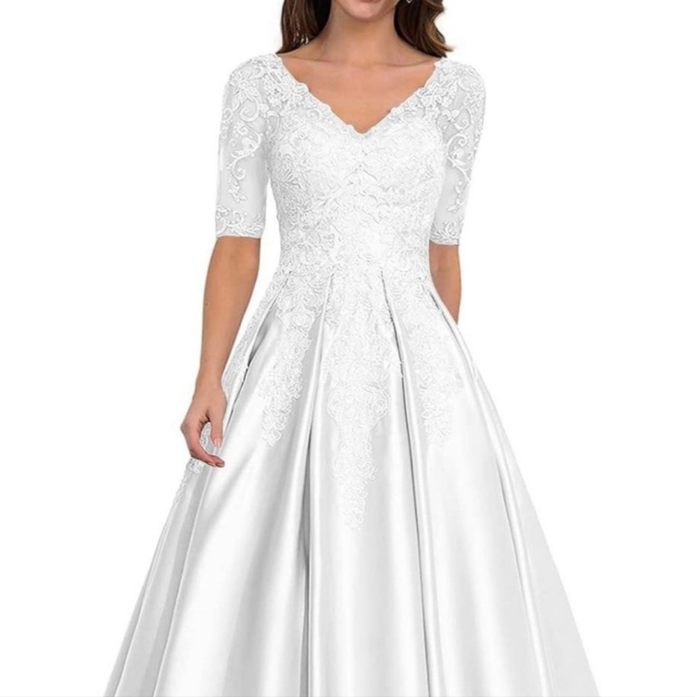 Never worn. Beautiful white Wedding Dress, size 16 NWT